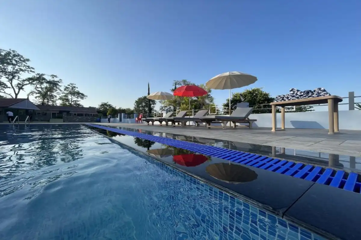 Outdoor swimming pool during daytime with clear water at B Hive Resort Londa
