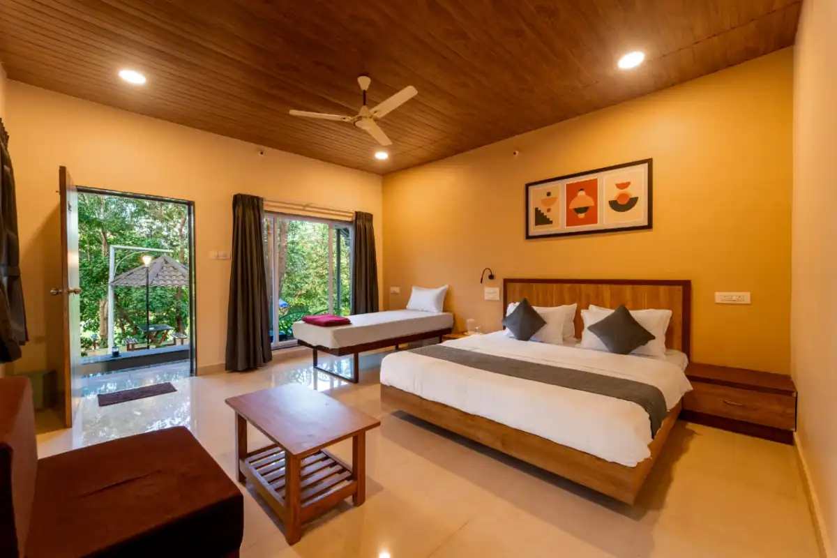 AC Deluxe room interior with pool view at Rain Forest Resort Dandeli