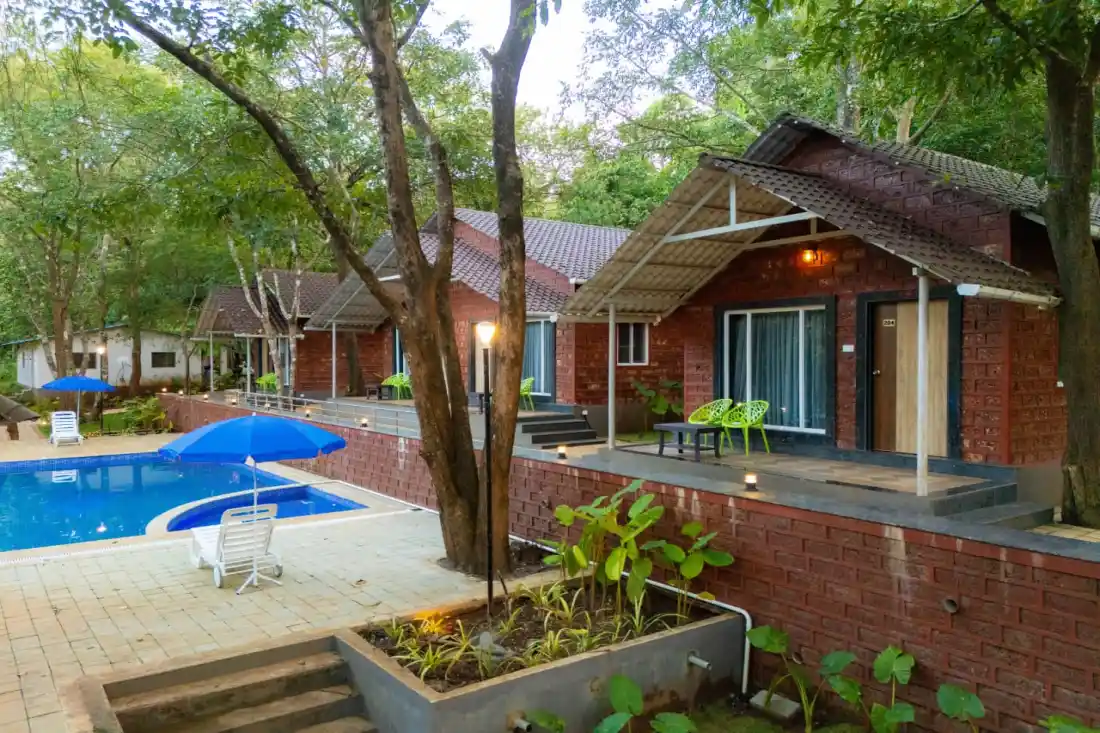 Laterite stone cottage by poolside at Rain Forest Resort Dandeli