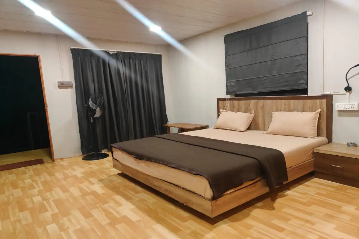 Non-AC Deluxe room interior with forest view at Rain Forest Resort